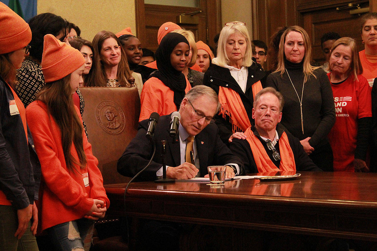 Governor Jay Inslee signs a ban on bump stocks on Tuesday, March. 6.