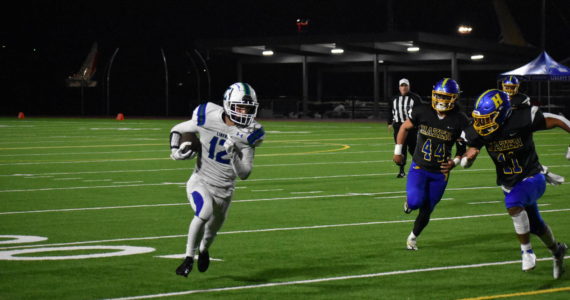 Liberty junior Jackson Moffitt gets the edge on the Hazen defense for a big gain.