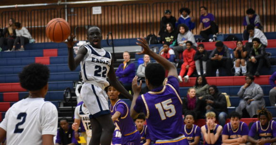 Eagle point guard sophomore John Choul dishes off a dime to freshman James Huff. Ben Ray/Sound Publishing
