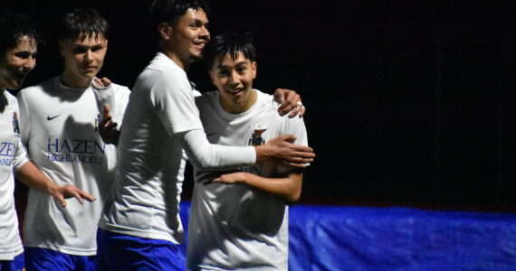 Jordan Stroud swarmed by teammates after he scores the first goal of the game. Ben Ray / The Reporter