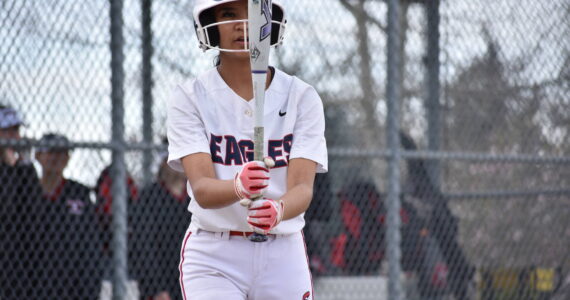 Raylyn Pocaigue looks at the barrel of her bat against Sammamish. Ben Ray / The Reporter