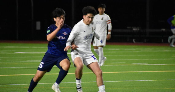 Joel Meliton Diaz (left) and Braylon Walker (right) battle it out for the ball. Ben Ray / The Reporter