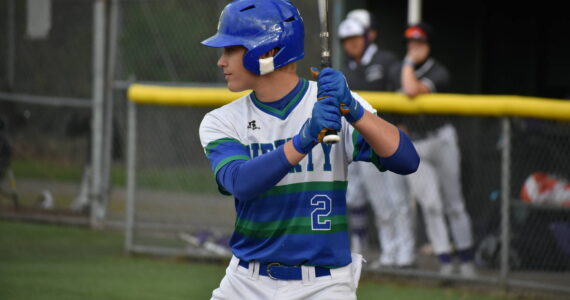 Mac Reynolds, in the batter’s box, eyes down the Kang pitcher late in the game against Lake Washington. Ben Ray / The Reporter