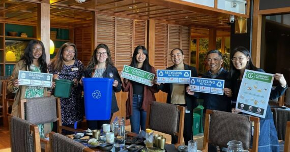 The outreach event at Anchovies and Salt. Meara Huebach and others are holding up some of the free supplies that program participants can receive. Photo courtesy of Meara Huebach