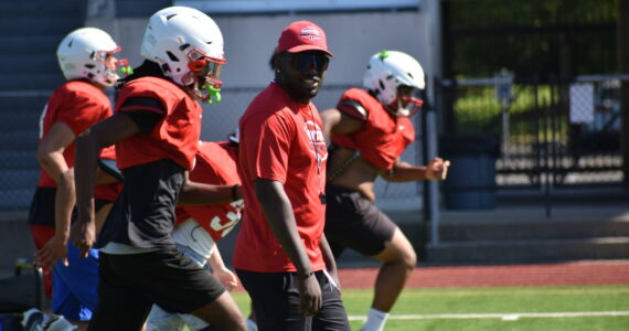Head Coach Bryce Jones leads the Redhawks during the conditioning part of practice. Ben Ray / The Reporter