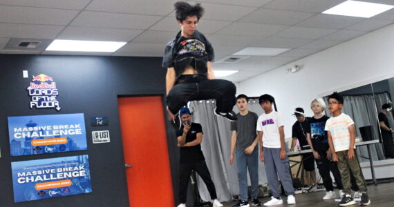 Zach, 14, jumps high into the air right before landing in a split. Photo by Bailey Jo Josie/Sound Publishing.
