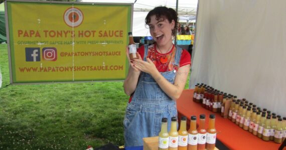 Raine Padawer, employee of Papa Tony’s, with her favorite flavor of hot sauce, the Ghostly Garlic. Photo courtesy of Annika Hauer