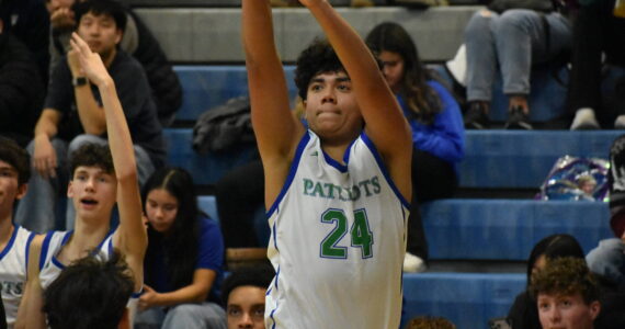 Sophomore Tyson Burley shoots a three point shot. Ben Ray / The Reporter