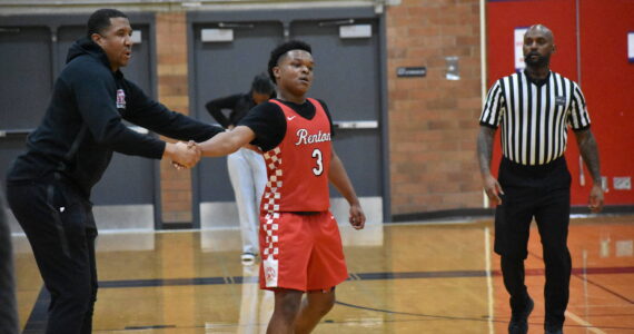 Isaac Elegan shakes hands with Head Coach Rashaad Powell in the win over Lindbergh. Ben Ray / The Reporter