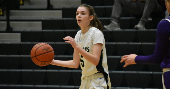Chelsea Irvine looks for a player to pass the ball to against North Thurston. Ben Ray / The Reporter