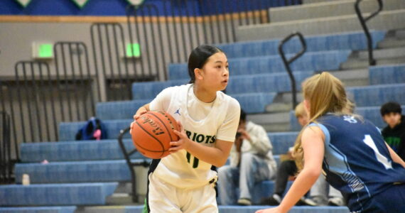 Aleah Tran looks for a teammate while running the offense. Ben Ray / The Reporter