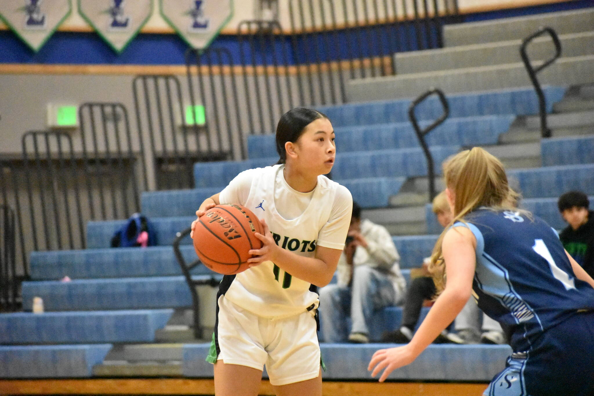 Aleah Tran looks for a teammate while running the offense. Ben Ray / The Reporter