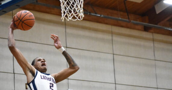 James Huff IV goes for a dunk against Evergreen. Ben Ray / The Reporter