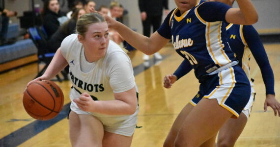 Ella Whitaker drives to the basket against Bellevue. Ben Ray / The Reporter