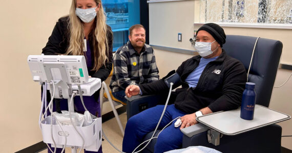 Samuel Martinez Santamaria (right) was one of the first patients to receive treatment at the new Cancer Center. He was attended by Licensed Practical Nurse (LPN) Leigha Baker (left) and supported by his husband Alex Shockey (center), who is also a Valley Medical Center employee. Photo courtesy of Valley Medical Center.