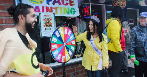 Mrs. Renton Ambassador Jennifer Brothers spins the wheel outside Smoking Monkey Pizza. Photo by Bailey Jo Josie/Sound Publishing