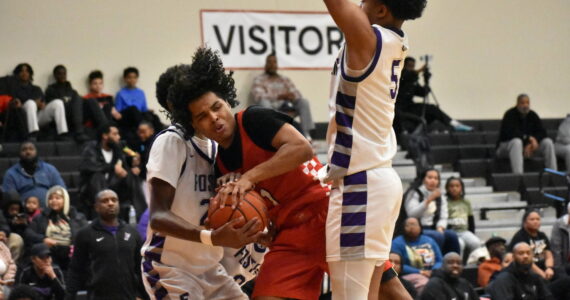 Jordan Agosto swarmed by Foster defenders in District 2 championship game. Ben Ray / The Reporter