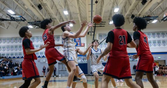 Isaac Roberts reaches for a pass against Silas. Photo taken by Maria Dorsten.