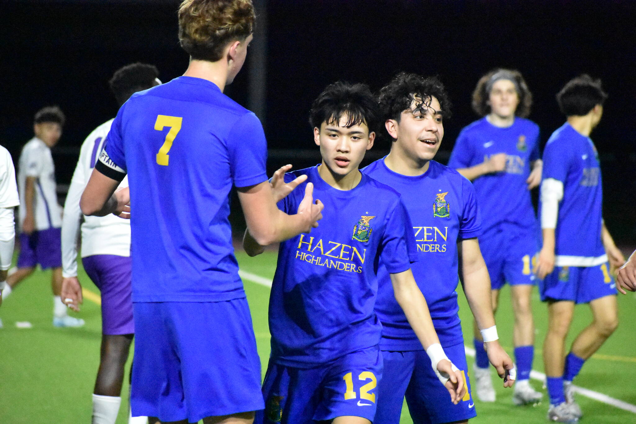 Stephen Cruz high fives Vitaly Polyukh after scoring the second Hazen goal of the game. Ben Ray / The Reporter