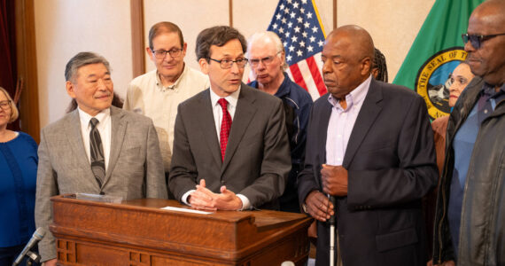 John Houston, right, as Gov. Bob Ferguson signs the bill into law. Photo courtesy of the Washington State Governor’s Office.