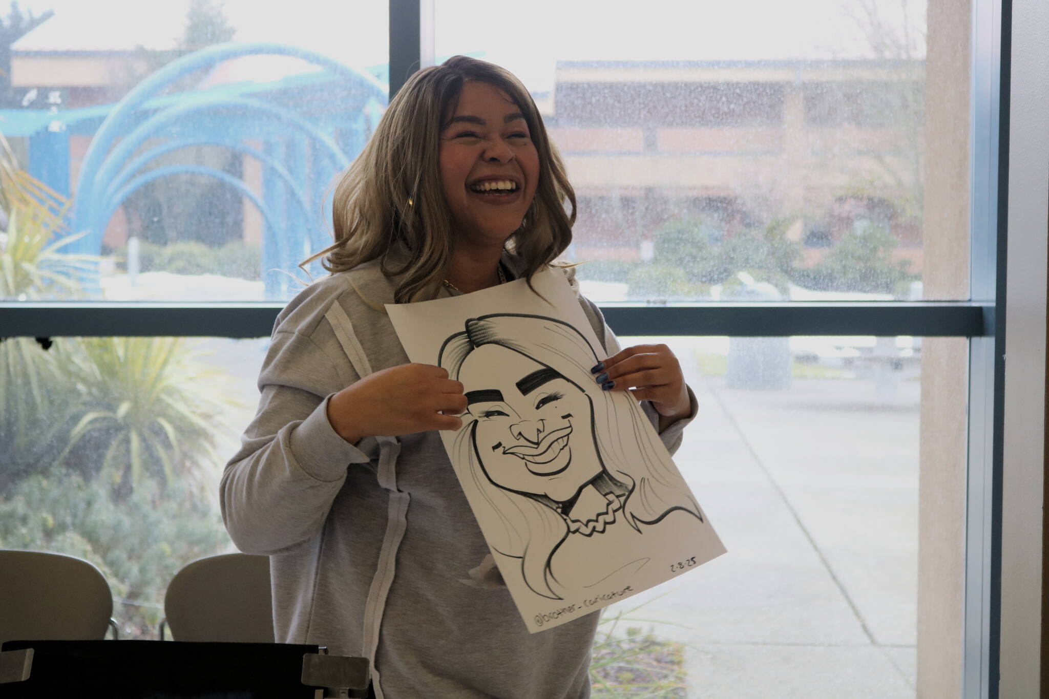 Fancy Vargas of Elevate PR will be the guest speaker at Renton Reporter’s next Read All About It chat night on April 29 at Drum Roll Wine. Vargas holds her caricature portrait by Markas Odom, who is @brother_caricature on Instagram. Photo by Bailey Jo Josie/Sound Publishing