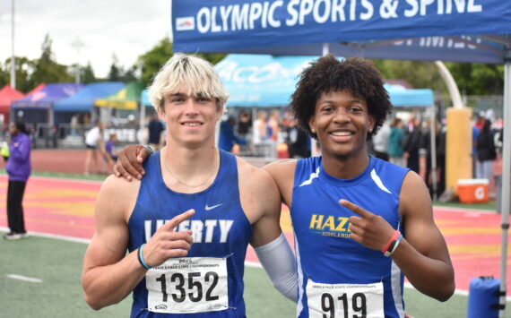 Kenyon Andrews (right) and Sutten Flint (left) pose after 300-hurdle race. Ben Ray / The Reporter