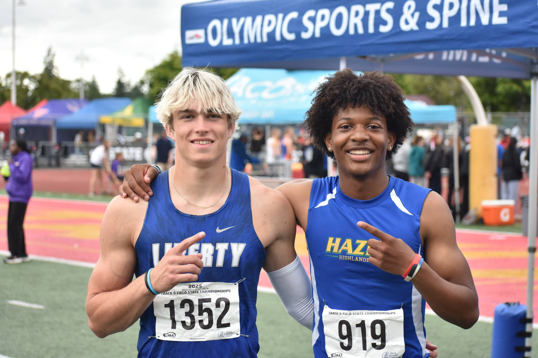 Kenyon Andrews (right) and Sutten Flint (left) pose after 300-hurdle race. Ben Ray / The Reporter