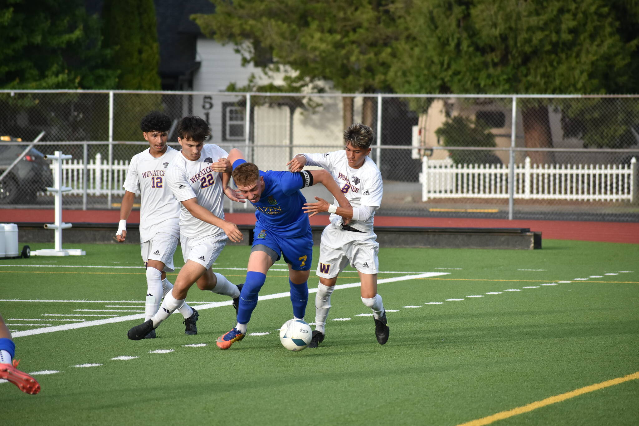 Vitaly Polyukh fends off three Wenatchee players. Ben Ray / The Reporter
