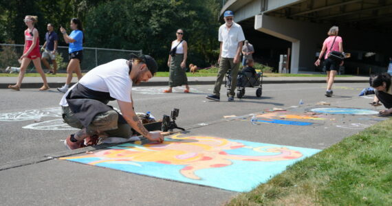 Michael Ingrassia works on his chalk art piece at last year’s competition. Photo provided by the City of Renton
