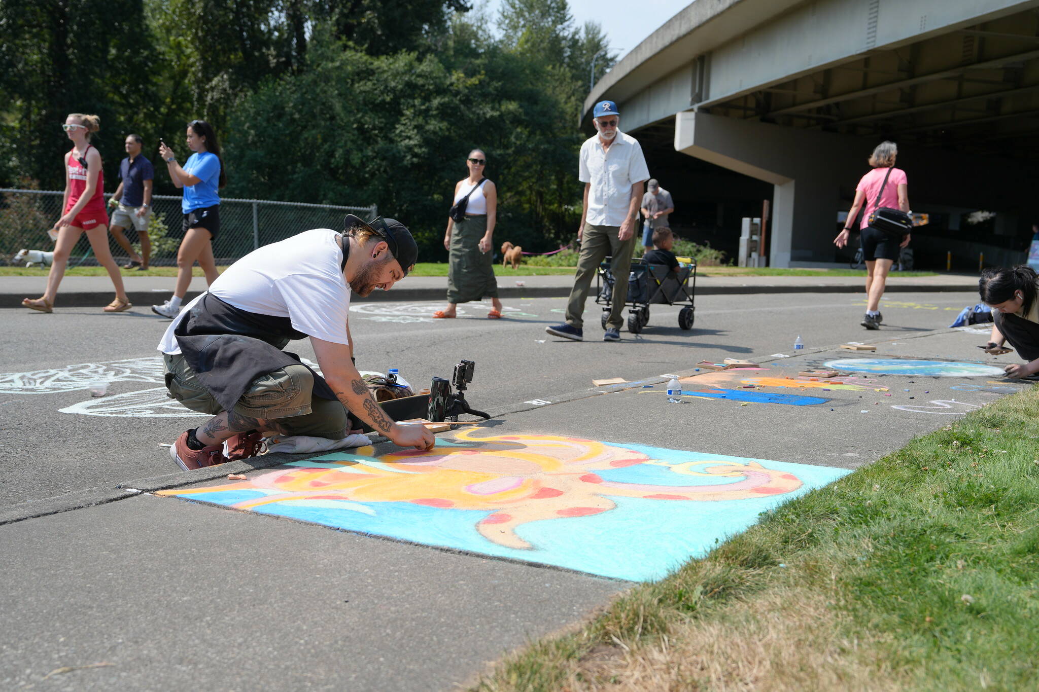 Michael Ingrassia works on his chalk art piece at last year’s competition. Photo provided by the City of Renton