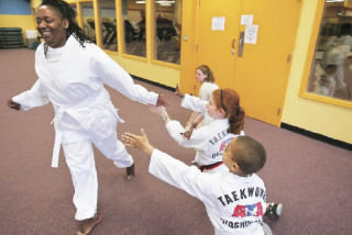 Felicia Sumareh gets a high-five from her foster son