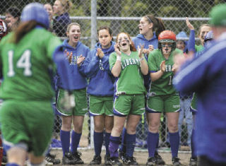 The Liberty softball team gathers at home plate to welcome home senior first baseman Michelle Torre (No. 14 at left) after she hit a homerun Thursday in a 5-4 win over Mount Si.