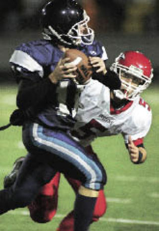 Renton’s Armin Basic pressures Mount Rainier quarterback Craig Robinson.