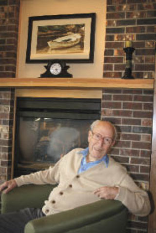 Maury Marler relaxes in the spacious  common area at Merrill Gardens in downtown Renton.